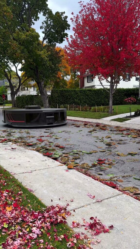 Giant robot vacuum sweeping leaves on a Mont-Royal street, CGI